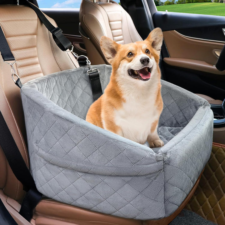 Corgi enjoying the ride inside a solid grey plush dog car seat with safety harness.