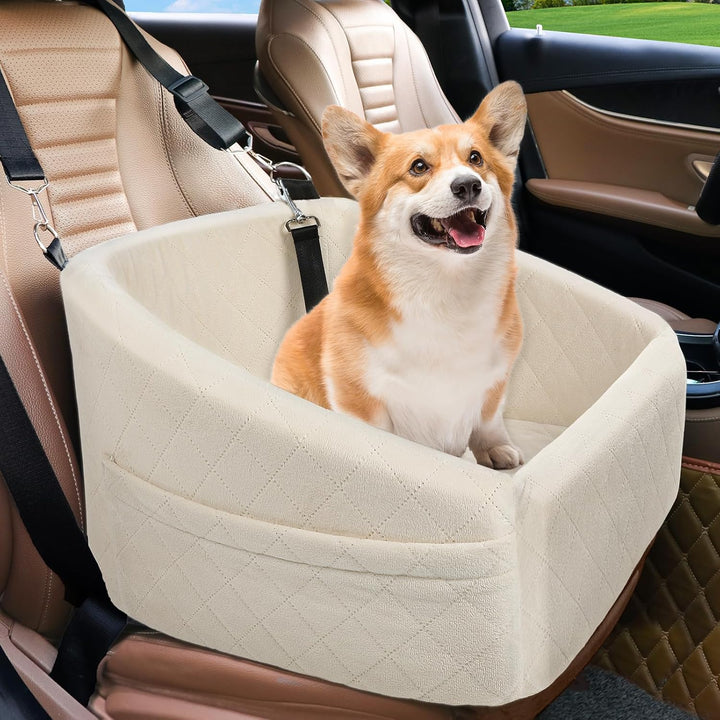 Corgi sitting comfortably in a beige dog car seat installed in a vehicle front seat.