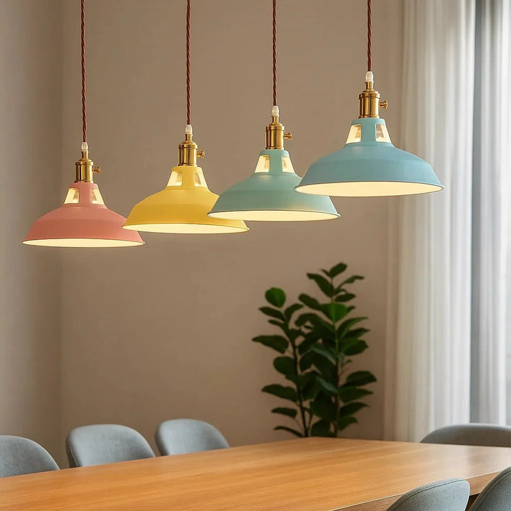 Assorted colored pendant lights hanging above a dining table