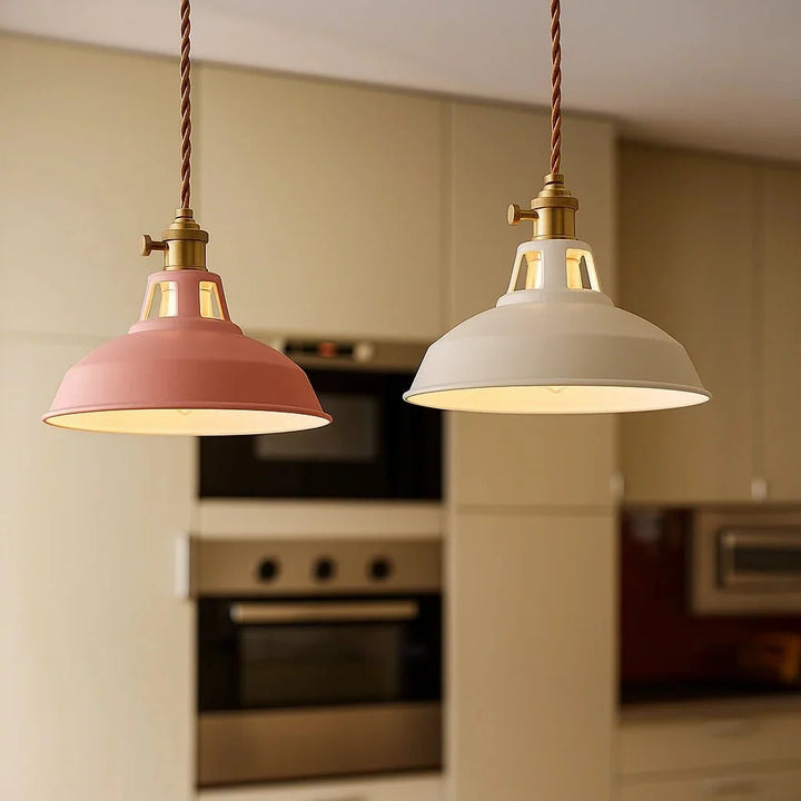 Pink and white dome pendant lights hanging in a modern kitchen