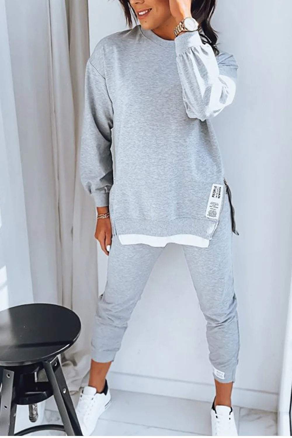 Woman wearing grey Marley loungewear two-piece set with long sleeves and tapered pants