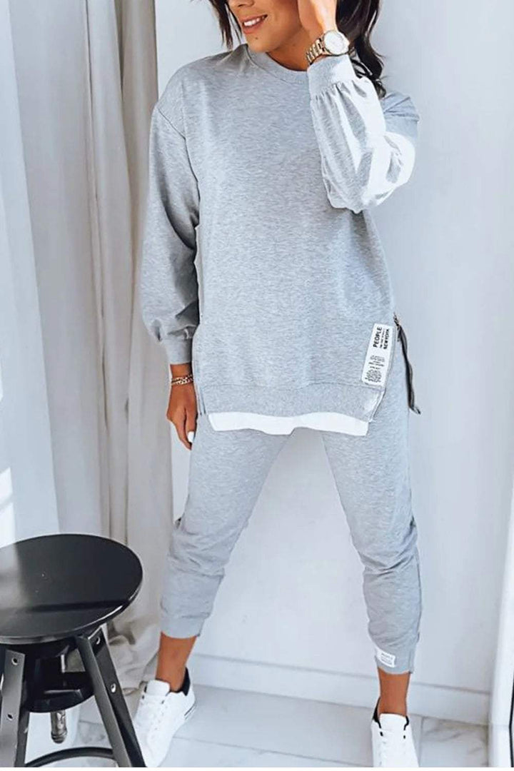 Woman wearing grey Marley loungewear two-piece set with long sleeves and tapered pants