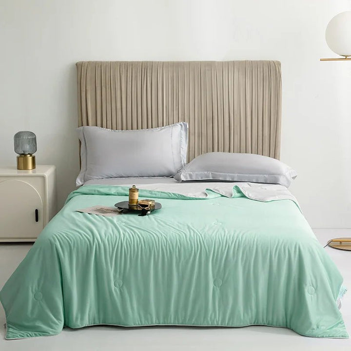 Refreshing summer blanket folded neatly to showcase dual-sided bedding comfort