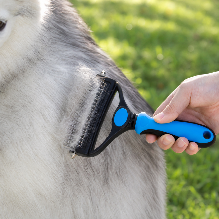 Dog grooming brush side view highlighting ergonomic handle for comfortable pet care.