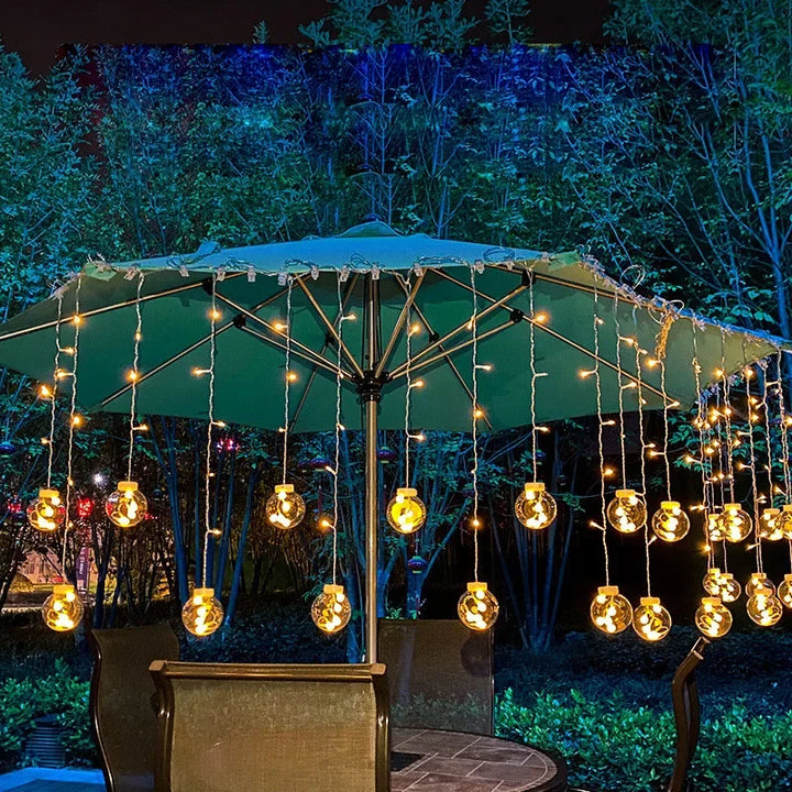 Multichromatic LED ball garland illuminating patio and garden decor