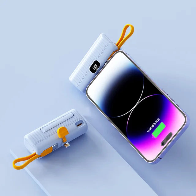Portable charger power bank resting on a wooden table with phone accessories