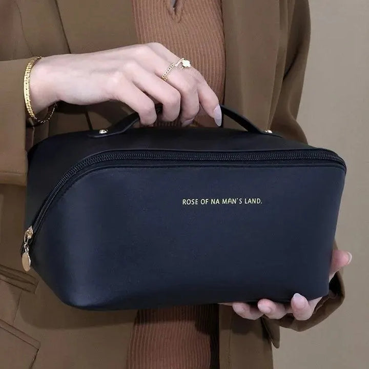 Portable toiletry pouch with convenient carry handle for trips