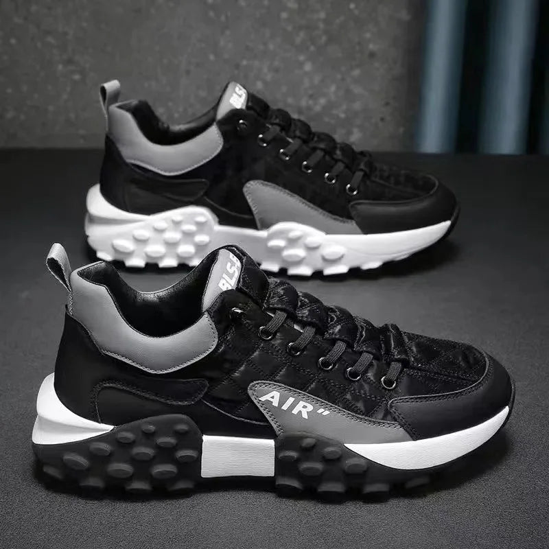 Pair of men's black orthopaedic trainers with thick patterned soles and white accents