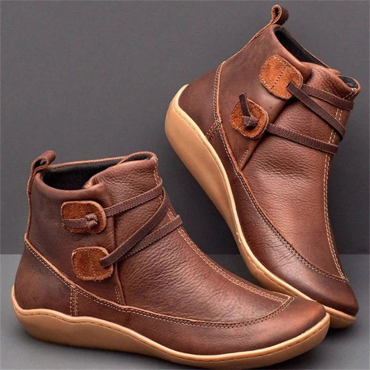 Brown women's orthopedic waterproof boots with decorative strap detail