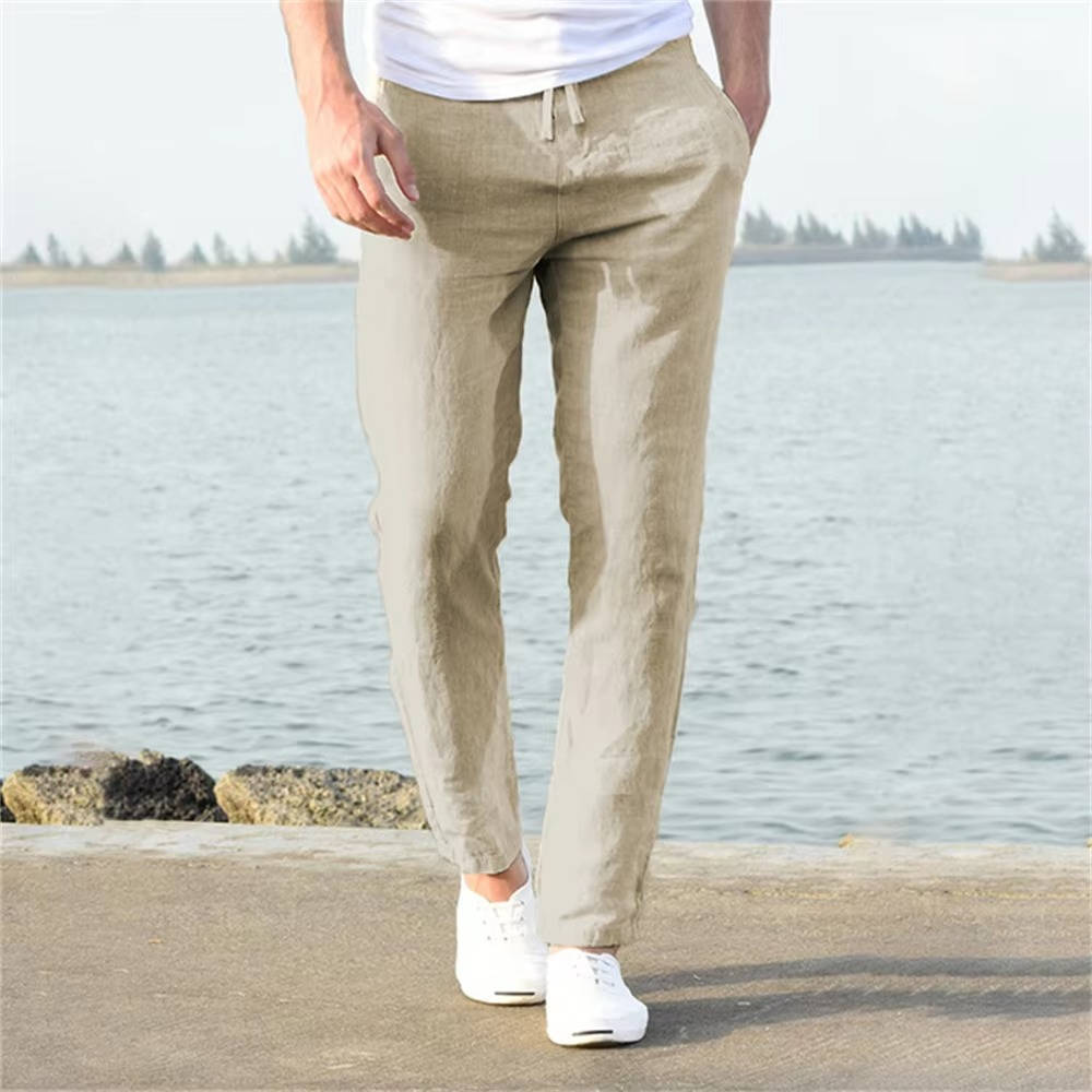 Man wearing light khaki relaxed trousers with adjustable waistband