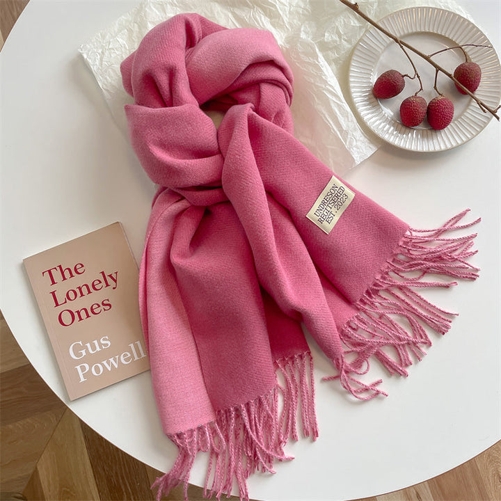 Women's reversible tassel wrap scarf folded neatly showing texture