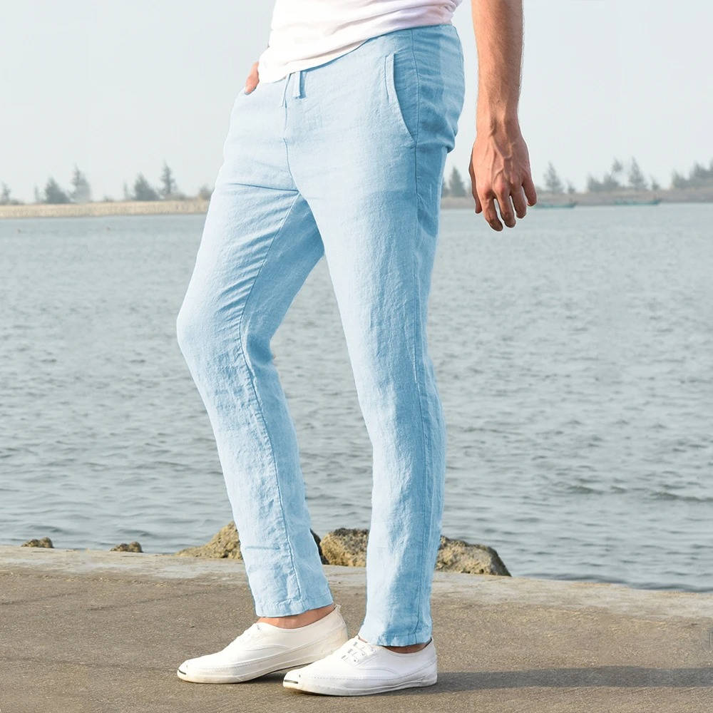 Side profile of man wearing light blue casual trousers outdoors