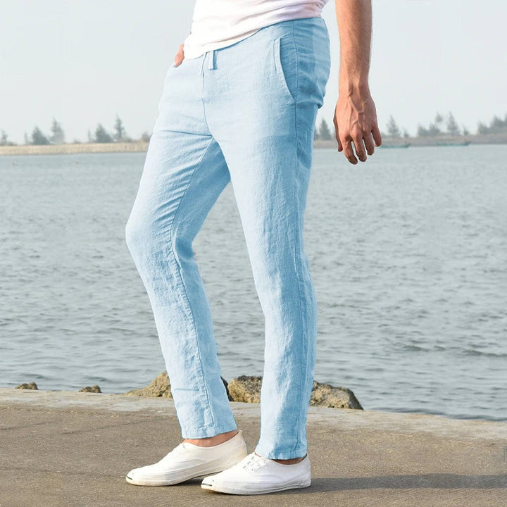 Side profile of man wearing light blue casual trousers outdoors
