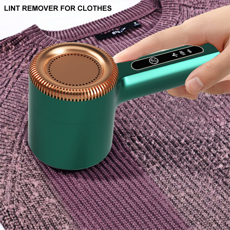 Electric garment care tool clearing fuzz from a sofa cushion