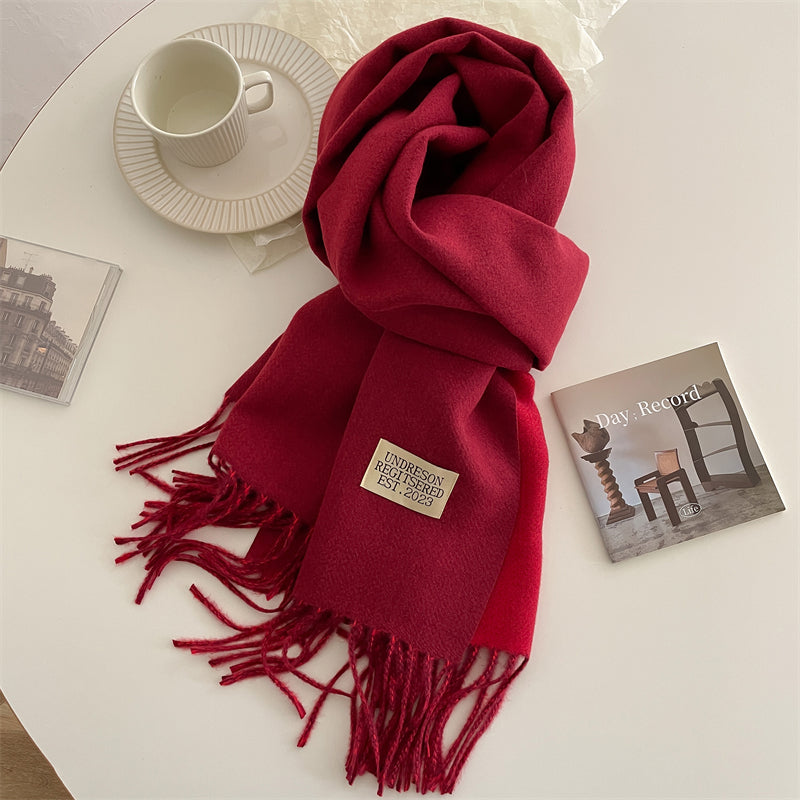 Soft womens scarf draped elegantly over a mannequin's shoulders