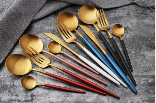 Elegant gold silverware set including forks, knives, and spoons