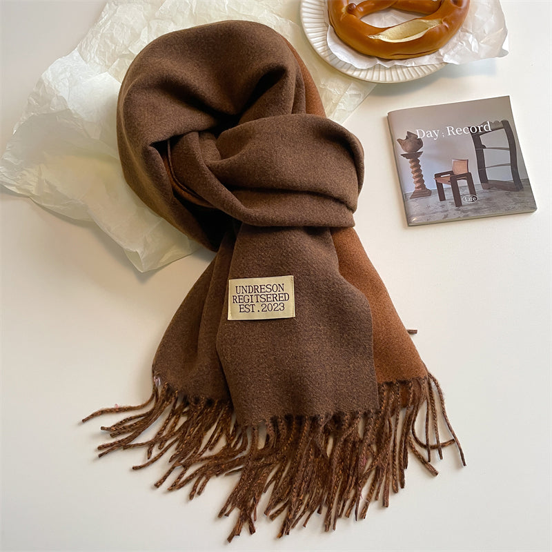 Detailed shot of decorative tassels on a cozy winter wrap scarf