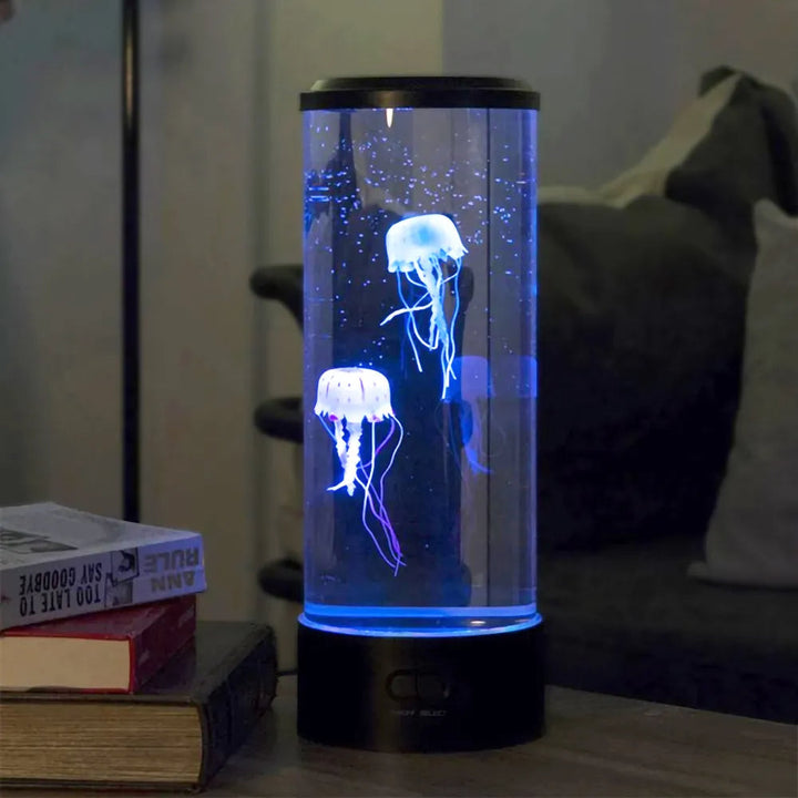 Jellyfish mood lamp glowing with blue light on a wooden desktop