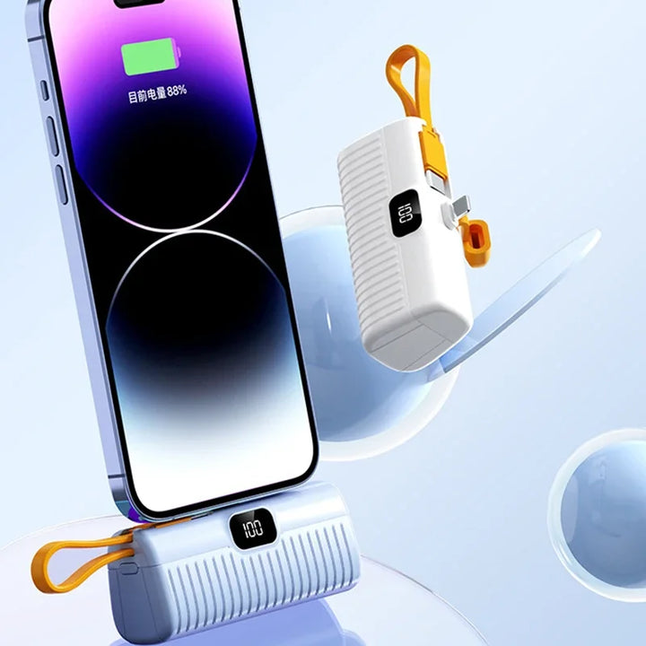 White portable power bank charging a smartphone on display stand