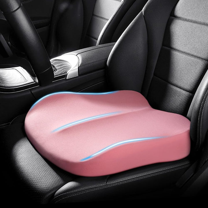 Pink memory foam car booster cushion installed on a vehicle seat
