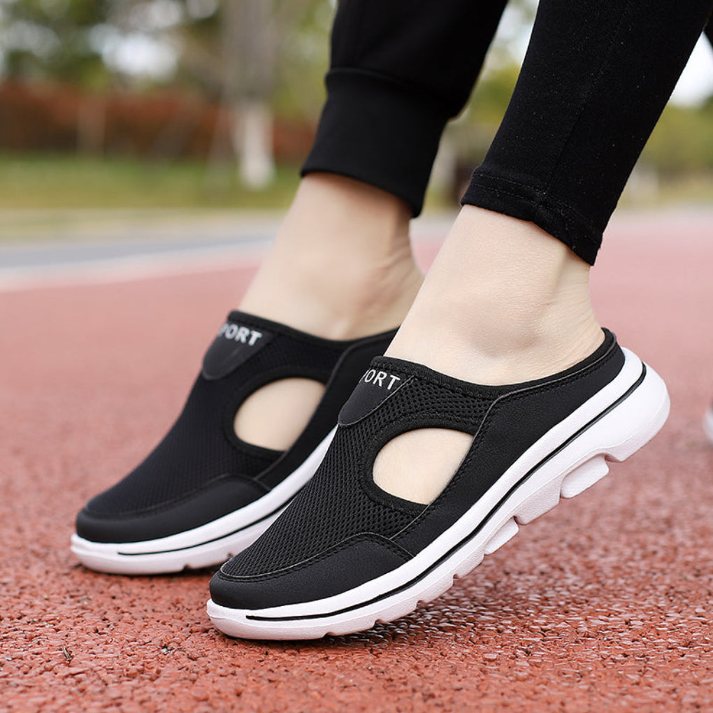 Women's black orthopedic slip-on sneaker mules worn outdoors