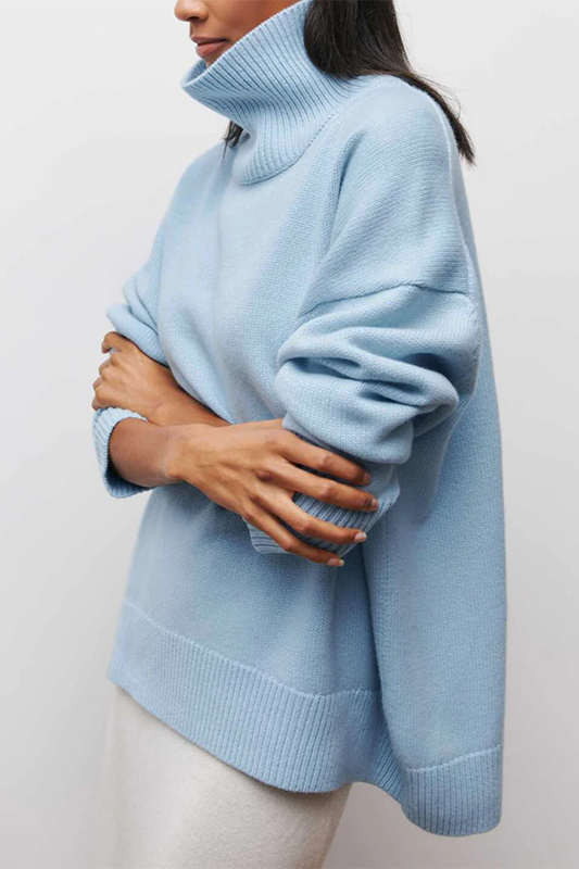Side view of a woman wearing a light blue cozy turtleneck knit sweater