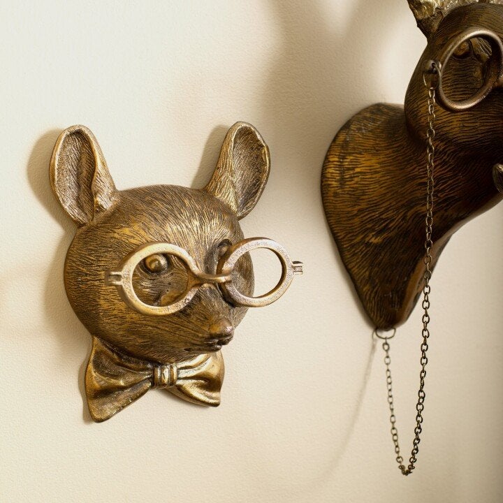 Decorative animal head wall art displayed on a gallery wall with complementary accessories