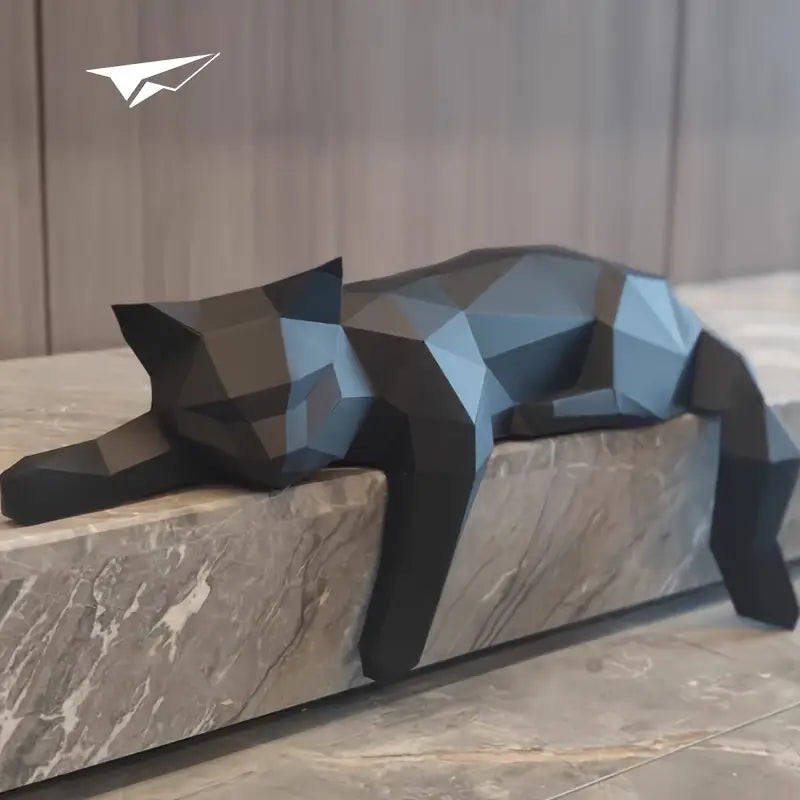 Dark modern cat sculpture resting on a stone mantelpiece