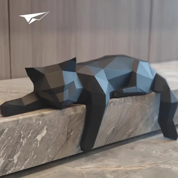 Dark modern cat sculpture resting on a stone mantelpiece
