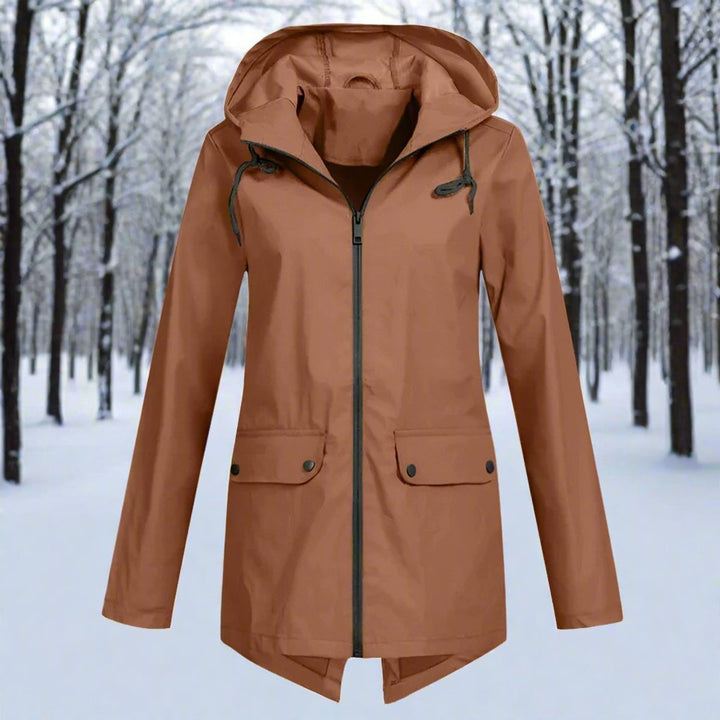 Lifestyle action shot of woman in waterproof coat walking outside