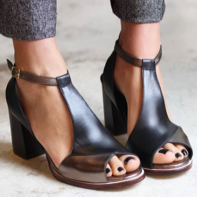 Women's black patchwork peep toe heels worn with cropped trousers