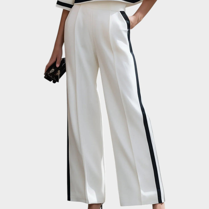 Close-up view of high-waisted wide-leg trousers with side stripes