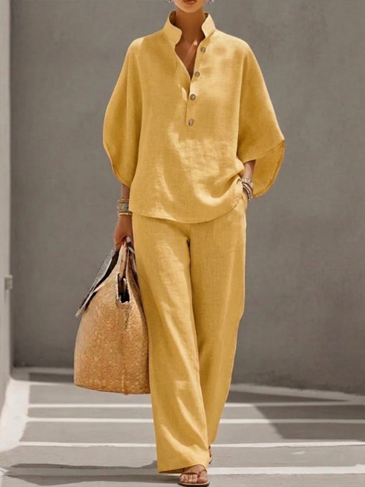 Flat lay of women's two-piece outfit showcasing top and wide leg pants