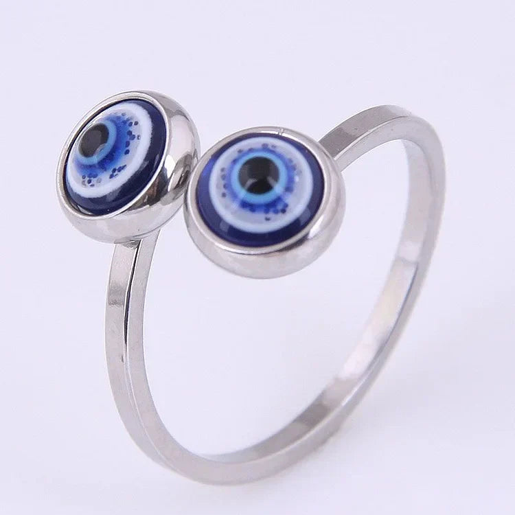 Close-up of the silver tone evil eye ring highlighting the flexible open band and polished finish
