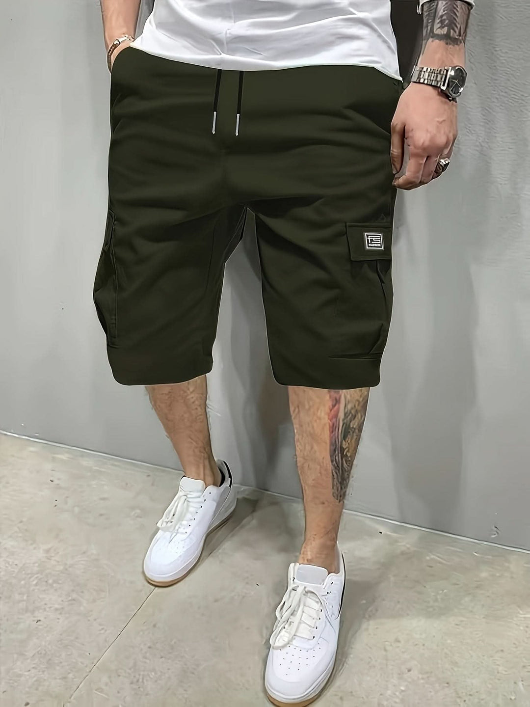 Man wearing army green casual utility shorts with functional pockets