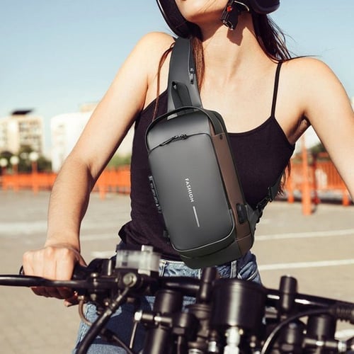Travel crossbody bag with USB charging port, side profile showing compact shape.