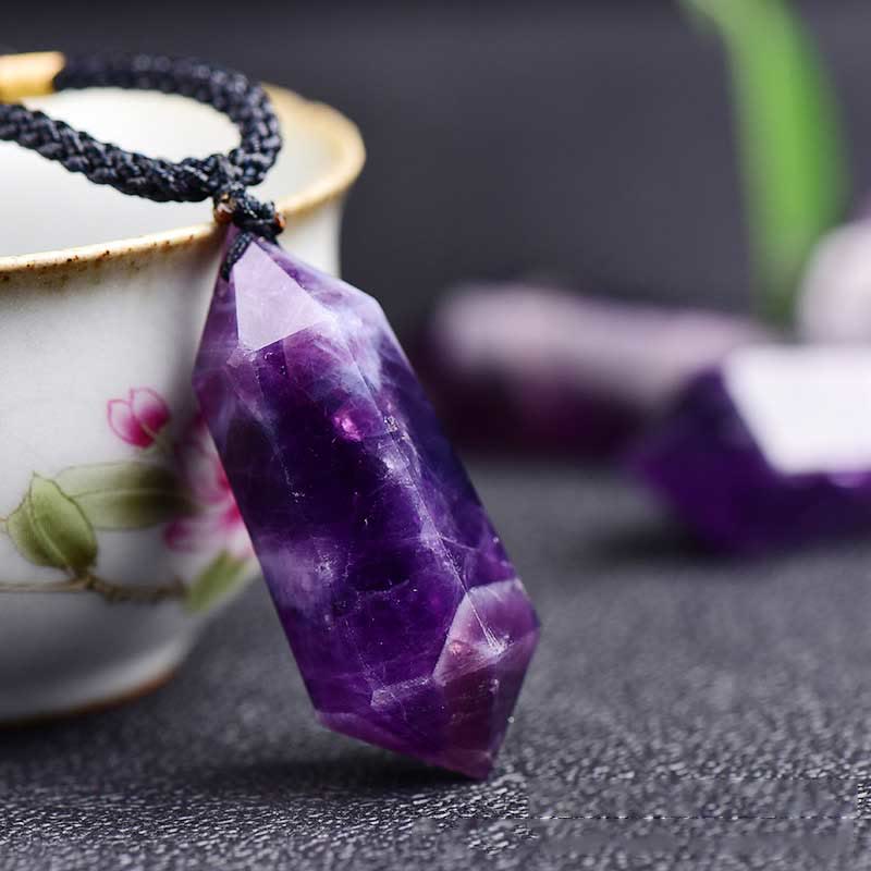 Polished gemstone pendant necklace reflecting soft light