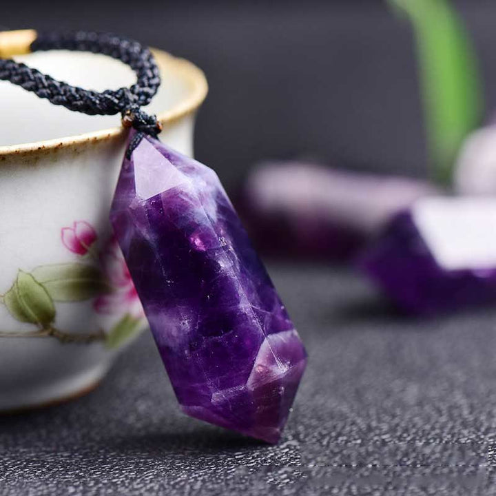 Polished gemstone pendant necklace reflecting soft light