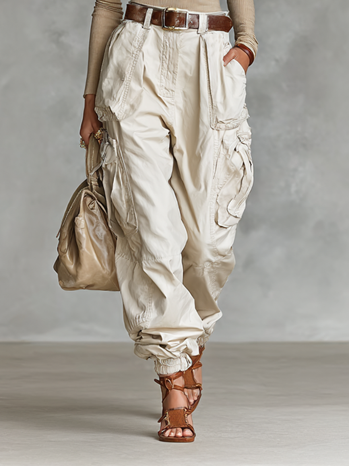 Detailed view of the relaxed fit cargo pants featuring spacious utility pockets and a belted waist.