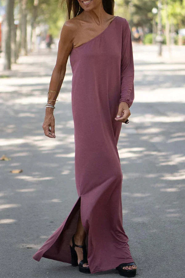 Woman wearing pink one shoulder maxi dress with single long sleeve