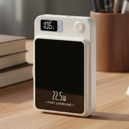Compact white power bank with digital display sitting upright on a wooden desk