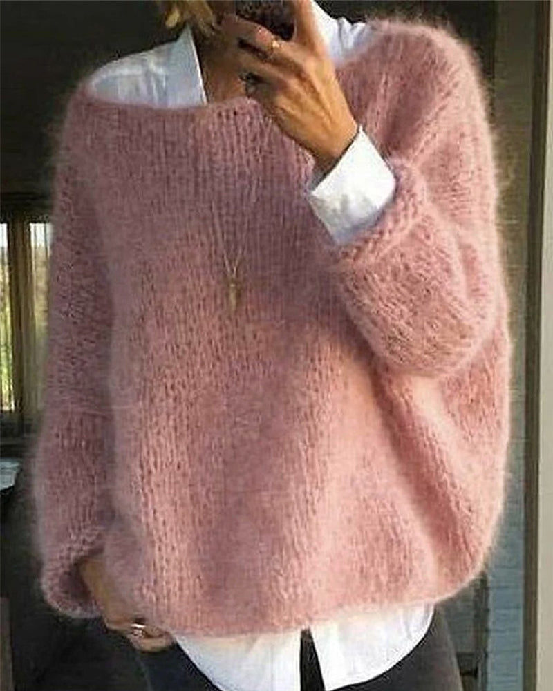 Woman wearing a soft pink oversized fuzzy knit sweater layered over a white shirt