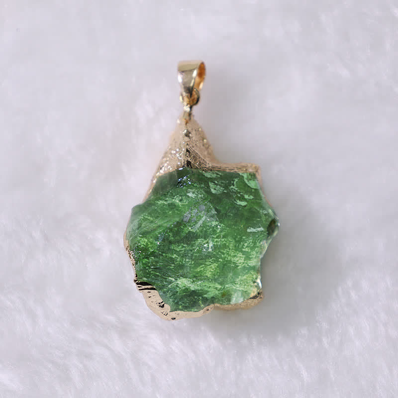 Natural Moldavite crystal pendant displayed against a neutral background
