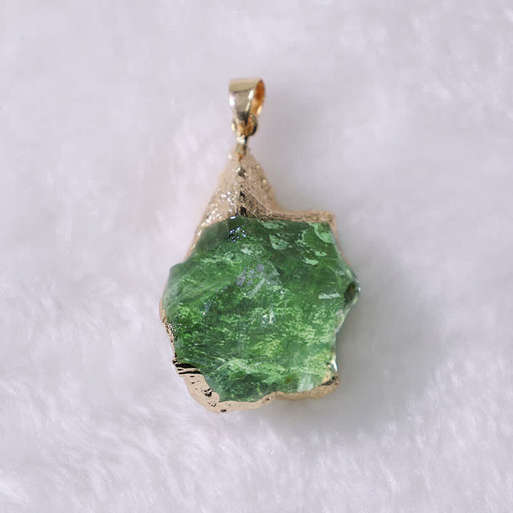 Natural Moldavite crystal pendant displayed against a neutral background