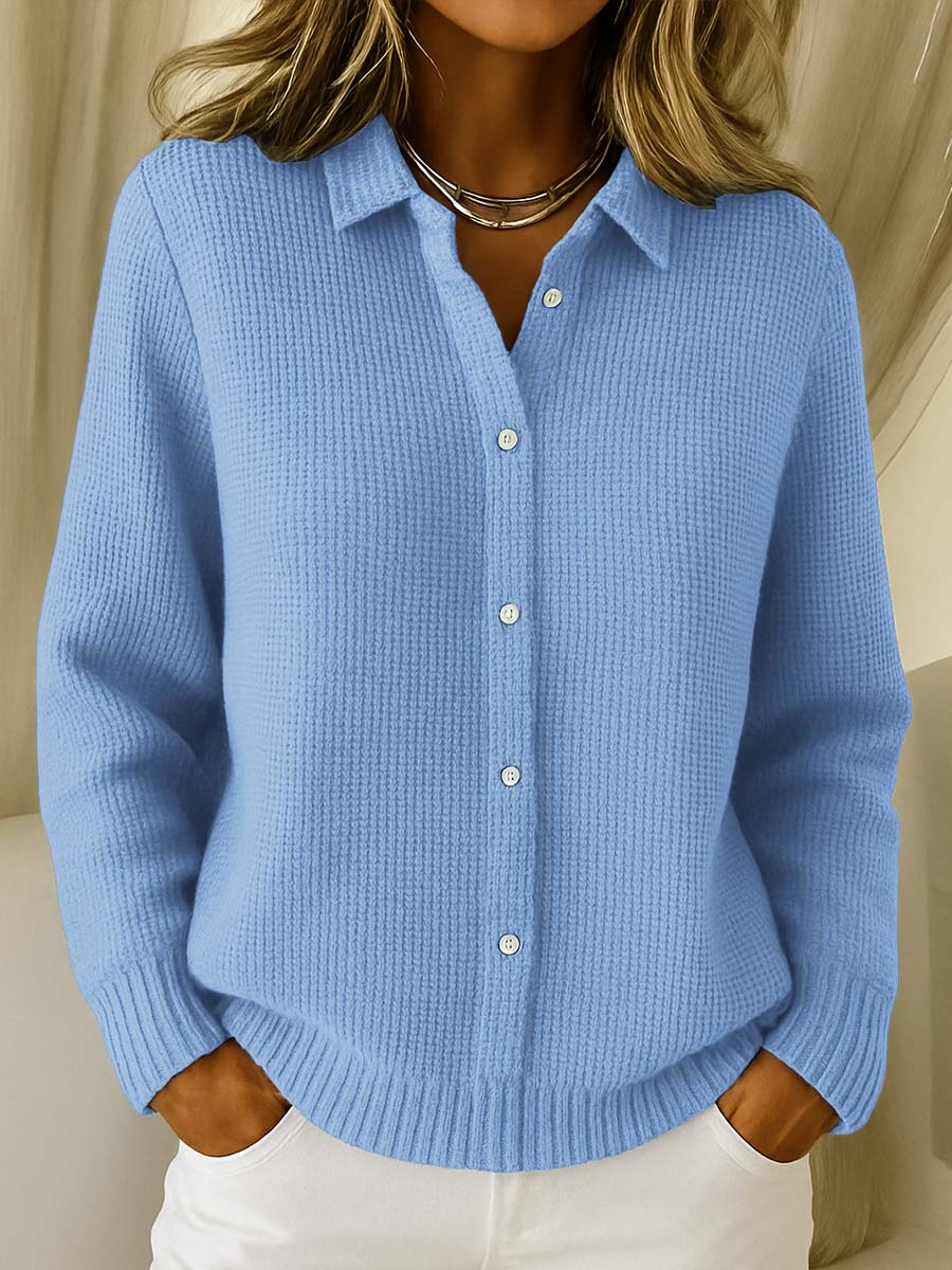 Woman wearing a light blue knit button-up cardigan with a collared neckline