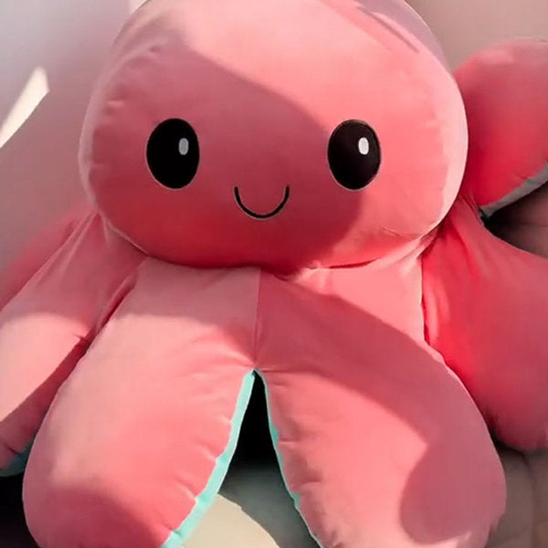Pink plush octopus toy close-up view