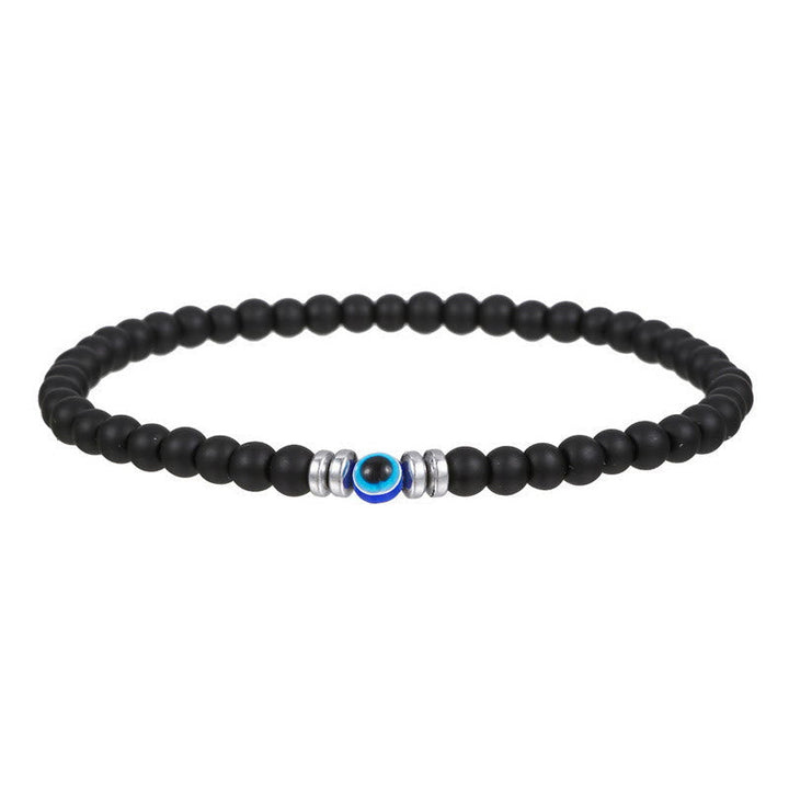 Studio product shot of the black natural stone evil eye beaded bracelet laid flat