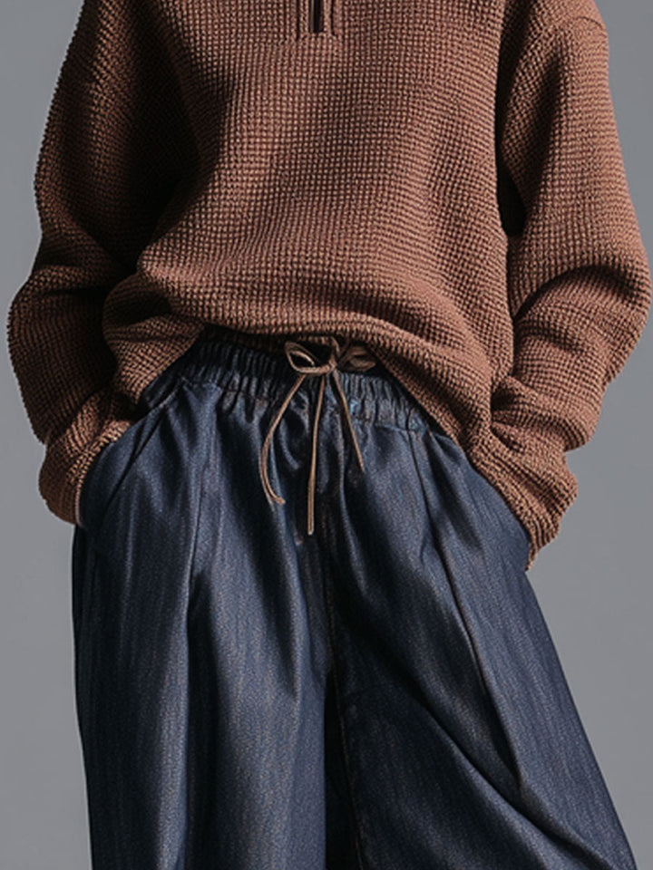 Close-up of waistband and pockets on navy blue lantern trousers