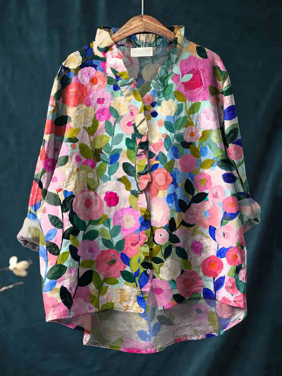 Women's multicolor floral long sleeve blouse hanging on a wooden hanger