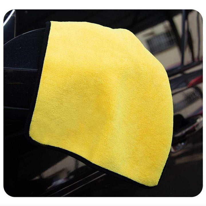 Textured microfiber car drying towel capturing dust and water effectively.